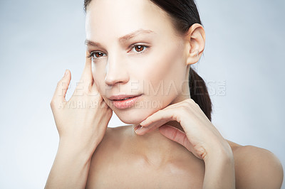 Buy stock photo Head and shoulder portrait of a beautiful young woman in the nude posing with hands on her face