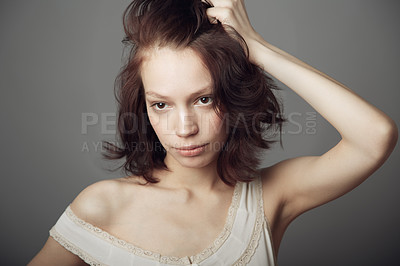 Buy stock photo A beautiful young woman posing with hands in her hair