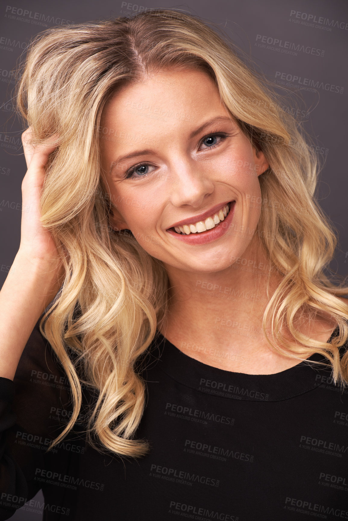 Buy stock photo Portrait of a beautiful young blonde woman smiling sweetly in studio