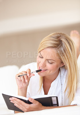 Buy stock photo Writing, notebook and thinking with woman on sofa for goals, diary and schedule. Calendar, relax and list with female person and journal in living room of home for self care, reflection and idea