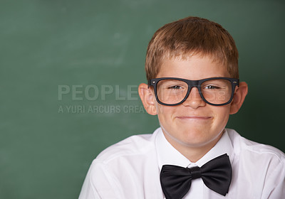Buy stock photo Happy boy child, portrait and chalkboard in classroom for learning, mockup space and education for future. Student kid, glasses and smile for studying, pride and school for knowledge with information