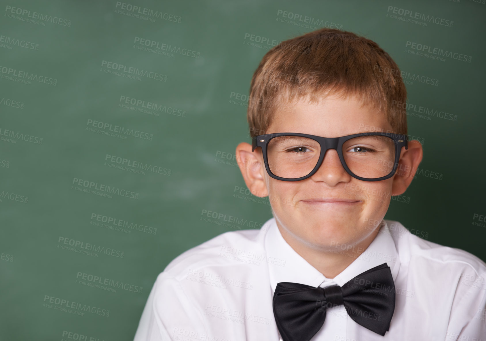 Buy stock photo Happy boy child, portrait and chalkboard in classroom for learning, mockup space and education for future. Student kid, glasses and smile for studying, pride and school for knowledge with information
