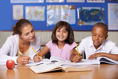 Buy stock photo Teacher, girl and school kids in classroom, portrait and writing, learning together and development with studying. Woman, children and help with notebook for support, teaching or education with smile