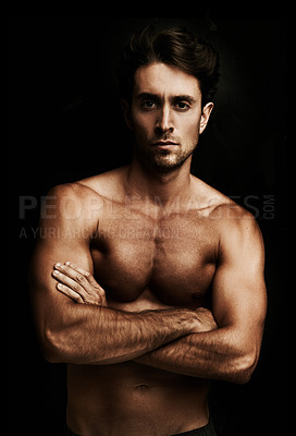 Buy stock photo Portrait of a well-built young man isolated on black with his arms crossed
