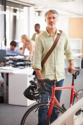 Buy stock photo Mature man, business and bicycle in office with portrait and manager of sustainable company. Ceo, boss and job with eco friendly commute in morning with smile in a creative agency of a professional 