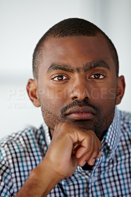 Buy stock photo Portrait of a serious African American man thinking while against a white background