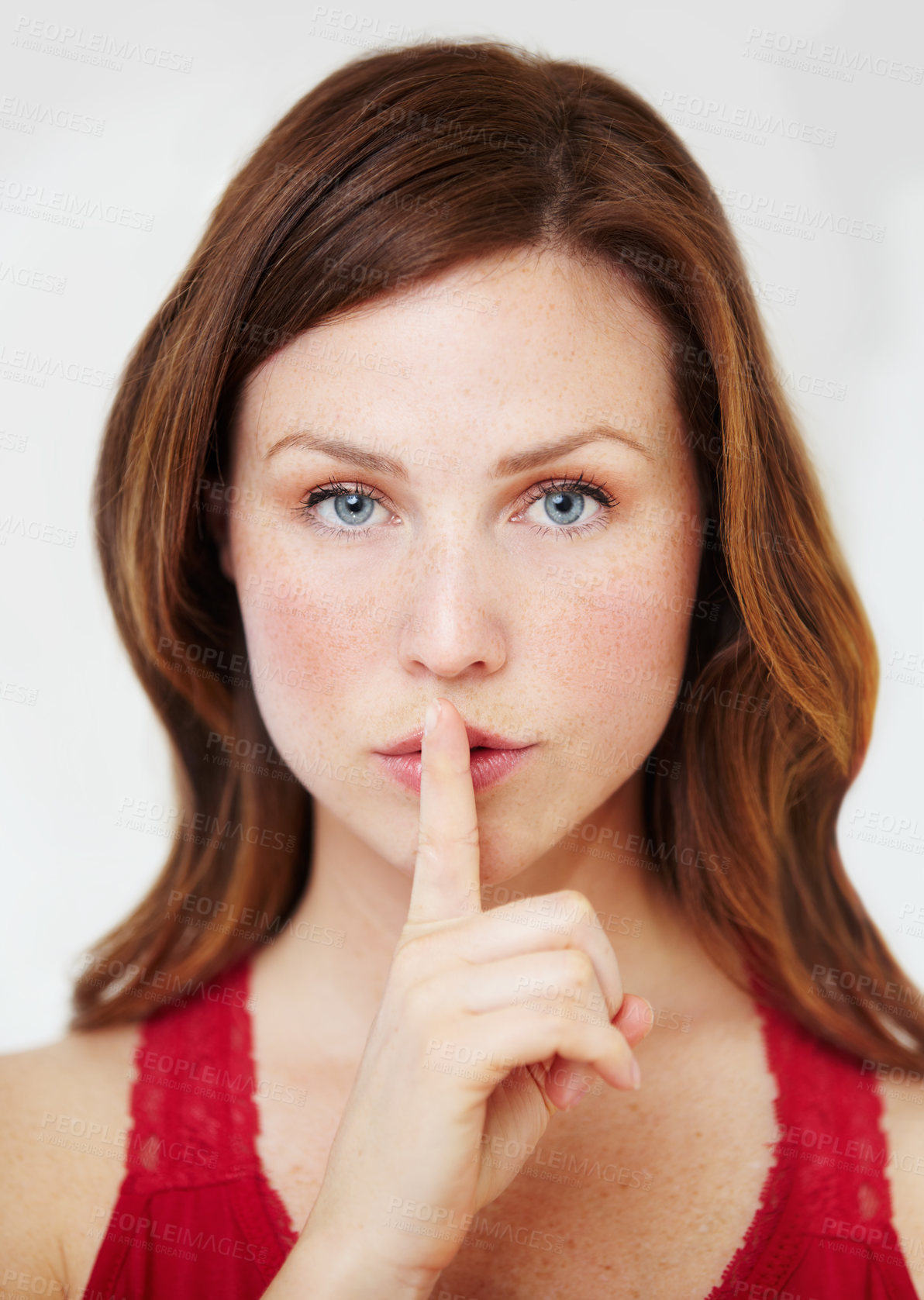 Buy stock photo Portrait of an attractive young woman with her finger on her lips