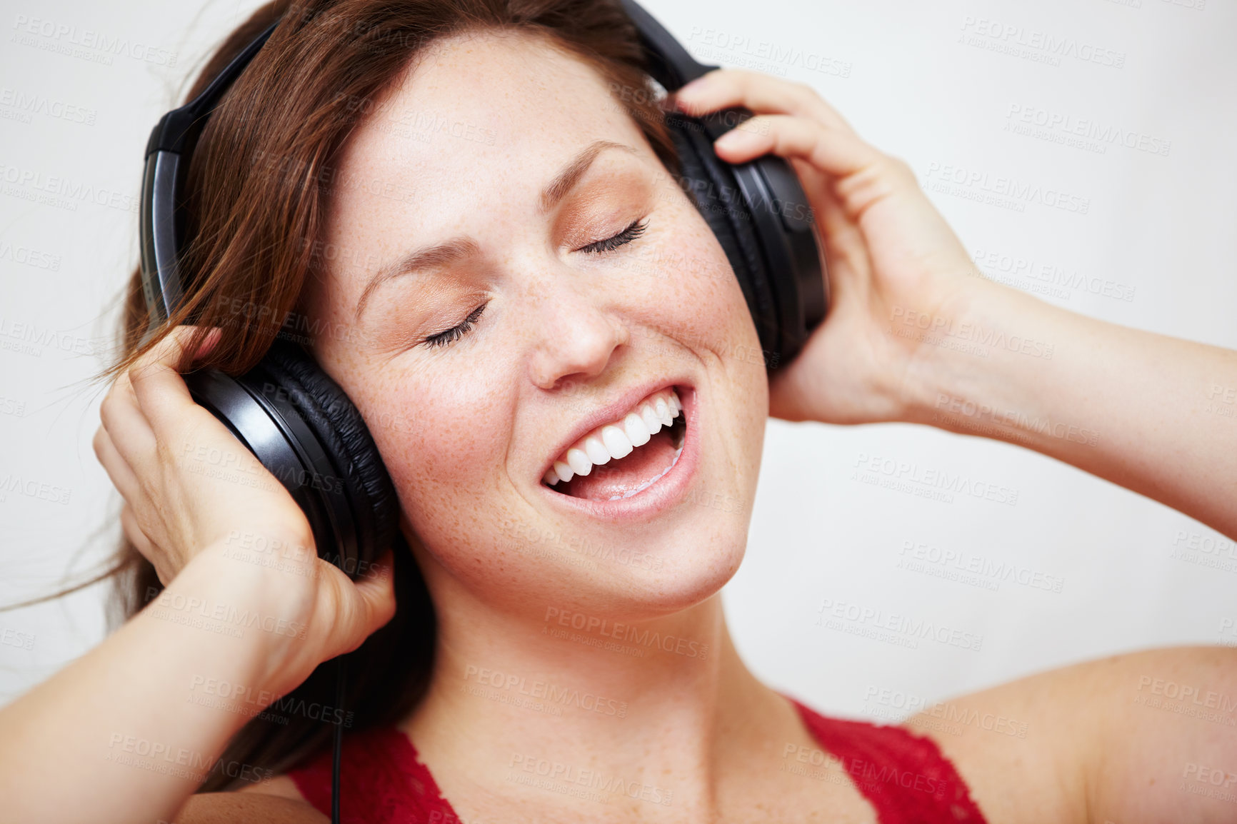 Buy stock photo Music, headphones and singing by happy woman in studio with audio, track or song on white background. Earphones, face and female person streaming podcast, radio or online playlist and subscription