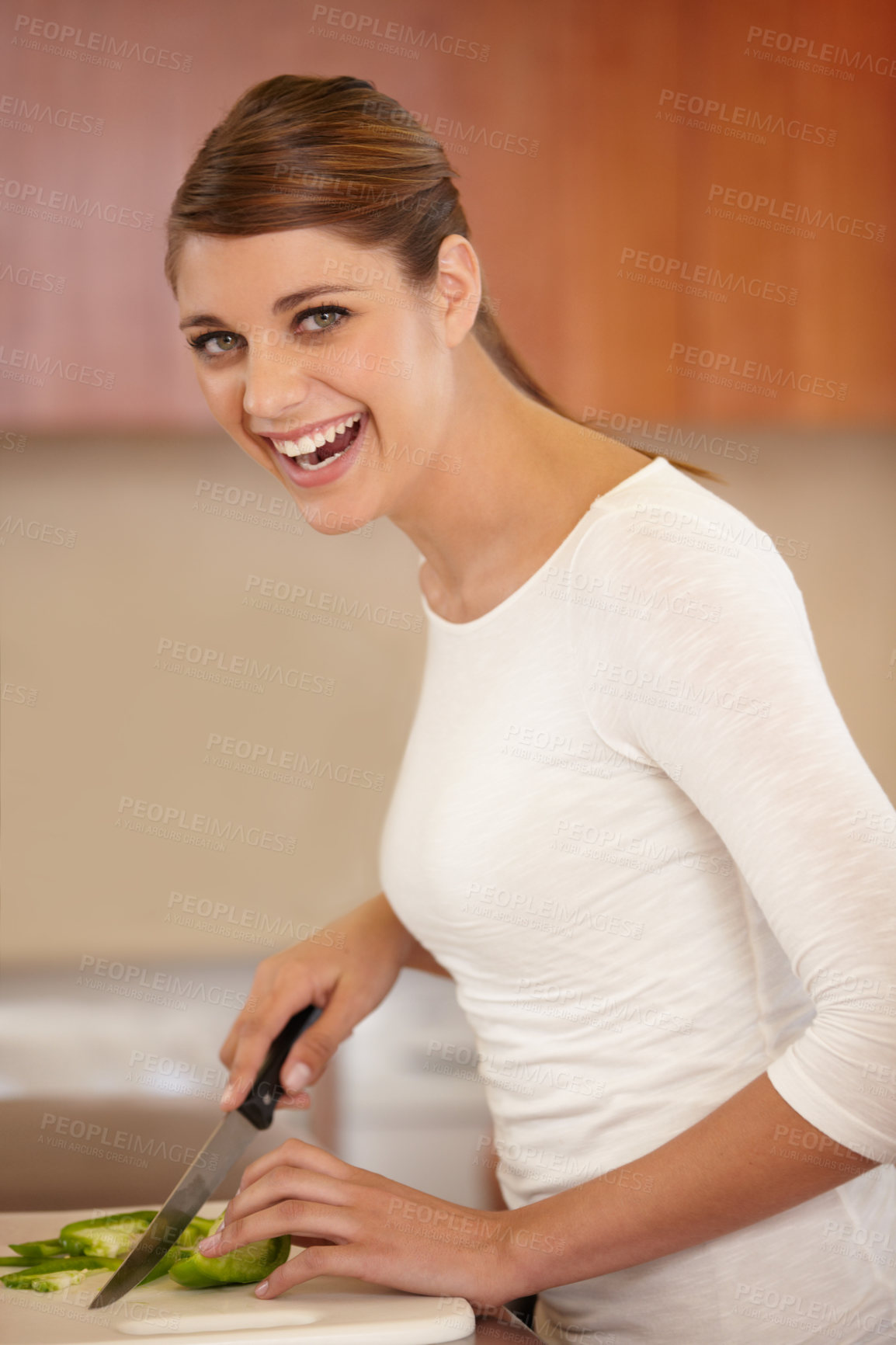 Buy stock photo Portrait of a beautiful young woman cooking in the kitchen
