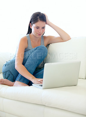 Buy stock photo Sofa, laptop and woman or student for internet, online education or search for sign up information on website. Young person relax on couch and typing on computer for subscription or streaming at home