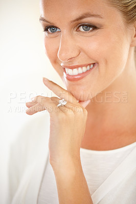 Buy stock photo An attractive young woman smiling and looking thoughtful