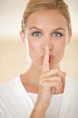 Buy stock photo Portrait of an attractive young woman gesturing for you to be quiet