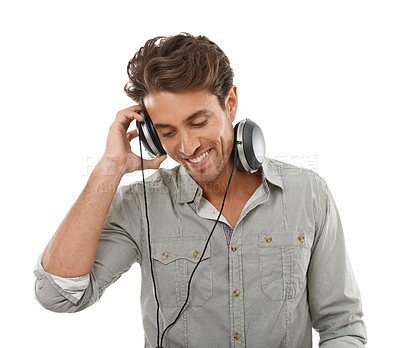 Buy stock photo Man, headphones and smile in studio for music, audio subscription or streaming multimedia on white background. Happy guy listening to podcast, hearing sound and radio for song, entertainment or album