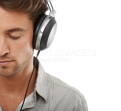 Buy stock photo Calm man, face and space with headphones in studio for audio subscription, streaming multimedia and radio on white background. Model listening to peaceful podcast, hearing sound and music with mockup