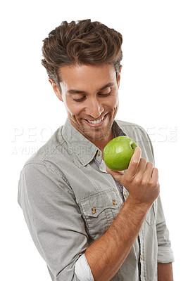 Buy stock photo Apple, healthy diet and happy man with food, nutrition and isolated on a white background in studio. Hungry person eating fresh green fruit, vegan and wellness benefits, vitamin c or organic detox