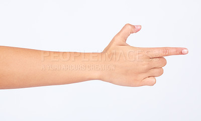 Buy stock photo Hand, finger and pointing with a woman in studio isolated on a white background making a gun gesture. Social media, icon and emoji with a female on blank space to choose a decision or point right