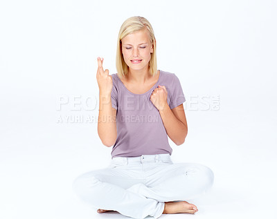 Buy stock photo Woman, hands or fingers crossed on mockup studio background, marketing space or advertising mock up. Nervous, beautiful model or hand gesture in hope, good luck wish and sitting on isolated backdrop