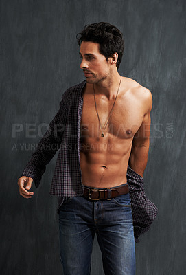 Buy stock photo Handsome, fashion and young man by a wall with trendy, cool and stylish outfit with confidence. Abs, attractive and male model from Canada with casual shirt and jeans posing by gray background.