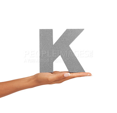Buy stock photo Hand of woman, capital letter K and presentation of consonant isolated on white background. Character, font and palm with English alphabet typeface for communication, reading and writing in studio.