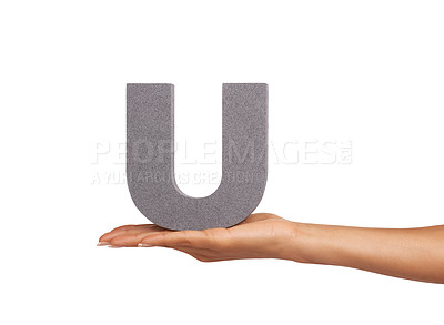 Buy stock photo A young woman holding a capital letter "U" isolated on a white background