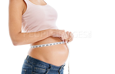 Buy stock photo Pregnant woman, measuring tape and stomach on a white background to check growth, development and health. Abdomen, wellness and pregnancy for self care, diet and healthy progress goals on mock up
