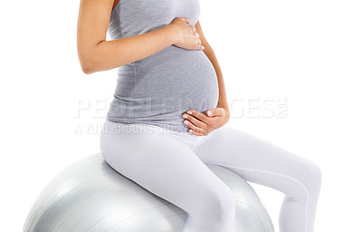 Buy stock photo Pregnant woman, stomach and sitting on exercise ball, white background and fitness, pilates and wellness. Pregnancy, medicine ball and workout in studio for healthy maternity, yoga training and body