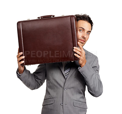 Buy stock photo Portrait of a young businessman peeking at you from around his briefcase