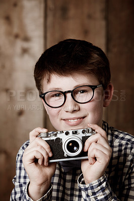 Buy stock photo Portrait, child and vintage for camera with happiness, mockup and positive in glasses by backdrop. Boy, smile face and nerd with photography in retro clothes and eyewear for creative kids with vision