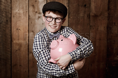 Buy stock photo Young child, hugging and piggy bank in portrait in studio background, retro money safe and cash savings in youth. Boy, smile and face for coin banking in vintage fashion and happy for dollars profit