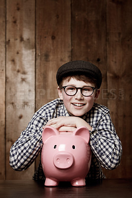Buy stock photo Piggy bank, smile and portrait of boy child with savings, growth or investment success in his home. Finance, learning and face of excited kid with money box for future education, funding or security