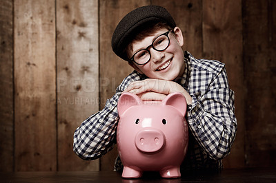 Buy stock photo Piggy bank, portrait and boy child smile with savings, growth or investment success in his home. Finance, learning and face of excited kid with money box for future education, funding or security
