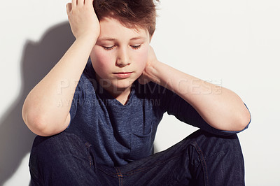 Buy stock photo Sad, teenager and boy thinking in studio or sitting in white background with anxiety from fail in school. Mental health, stress and kid worry with depressed emotions, ideas and pressure from mistake