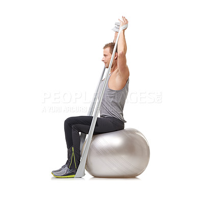 Buy stock photo Yoga ball, resistance band and man doing exercise in studio for health, wellness and bodycare. Sport, fitness and young male person from Australia with arms workout or training by white background.