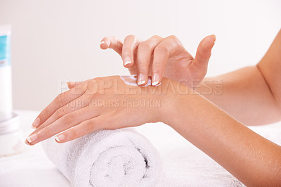 Buy stock photo Touch skin, cream and hands in spa, closeup and massage on towel for care. Fingers, nails or person apply lotion in treatment, natural cosmetics or dermatology moisturizer, beauty health and manicure