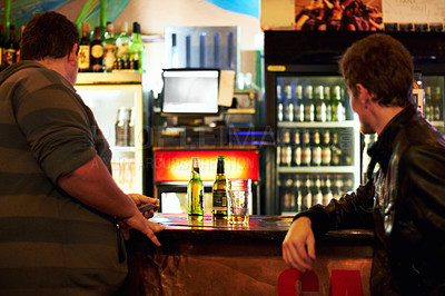 Buy stock photo Bar, alcohol and men for talking, conversation and social gathering for celebration at night. Beer, liquor and male friends waiting for service at counter for bonding, chat and relax together in pub