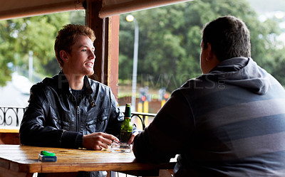 Buy stock photo Men, friends and drinking beer at a pub and restaurant with conversation and discussion. Alcohol, guys and young people together at diner with alcohol and drink with bottle and cigarette at table