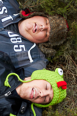 Buy stock photo Hangover, drunk and men sleeping on grass with tongue out in top view after party. Outdoor, alcoholism and tired friends on ground together with plus size person resting in a park in the morning.