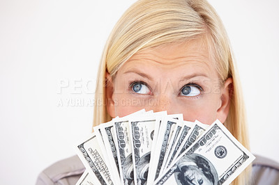 Buy stock photo A young woman wondering what to do with her cash