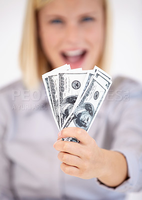 Buy stock photo A young woman showing you a wad of cash excitedly