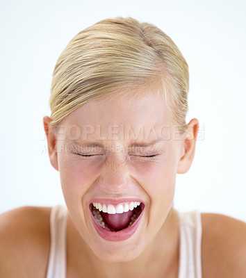 Buy stock photo A frightened young woman shrieking with her eyes closed
