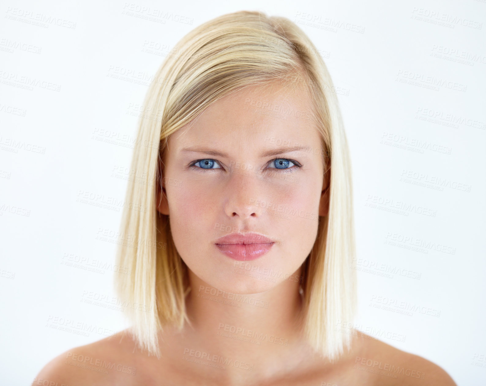 Buy stock photo Head and shoulders portrait of a pretty young blonde staring at your seriously