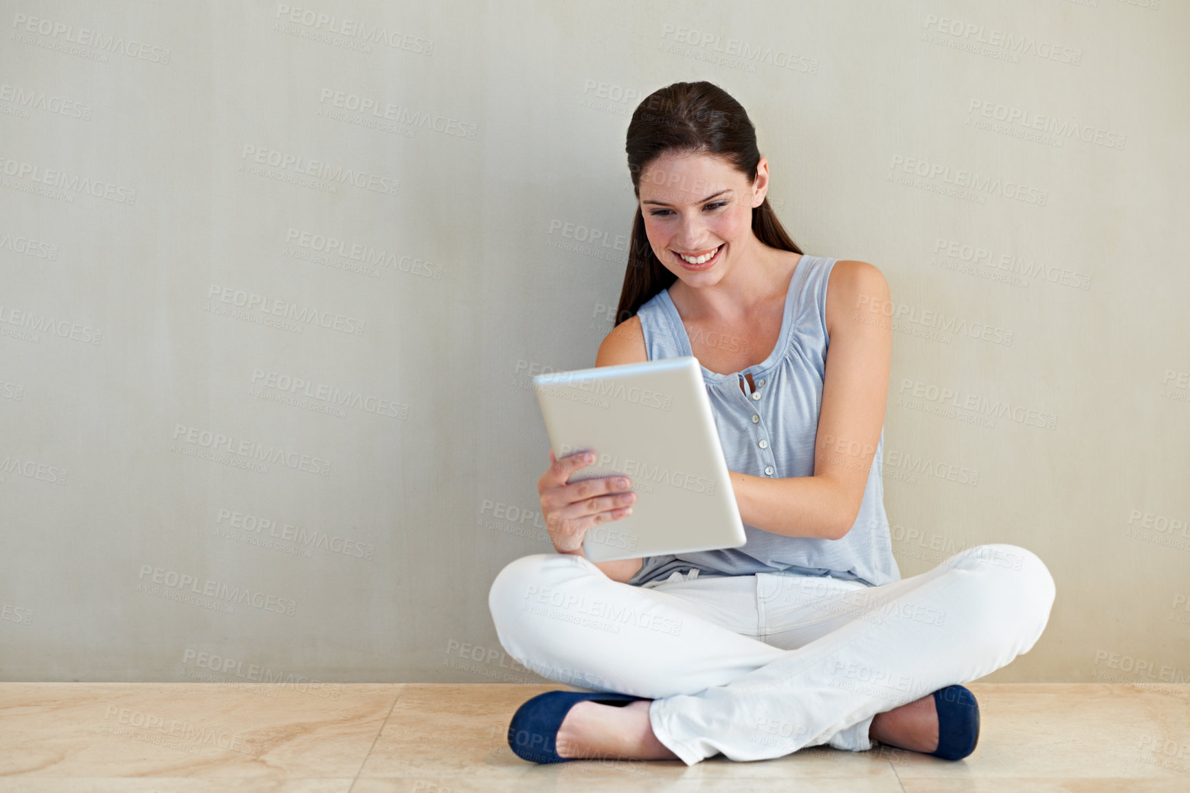 Buy stock photo Happy woman, tablet and social media for communication or networking with mockup space. Female person or freelancer smile and sitting against wall with technology for online research, vlog or reading