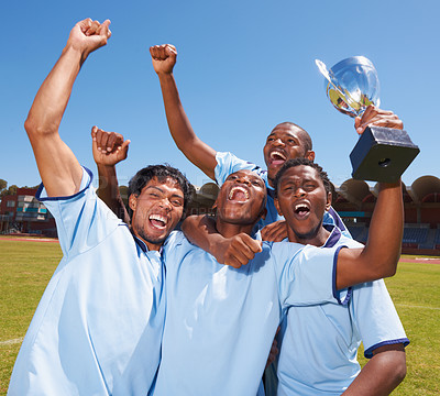 Buy stock photo A victorious soccer team celebrating their trophy success
