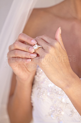 Buy stock photo Beautiful bride in her wedding dress touching her wedding ring
