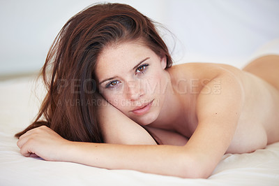 Buy stock photo A stunning young woman lying naked on her bed