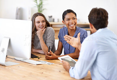 Buy stock photo A group of designers discussing something in their office