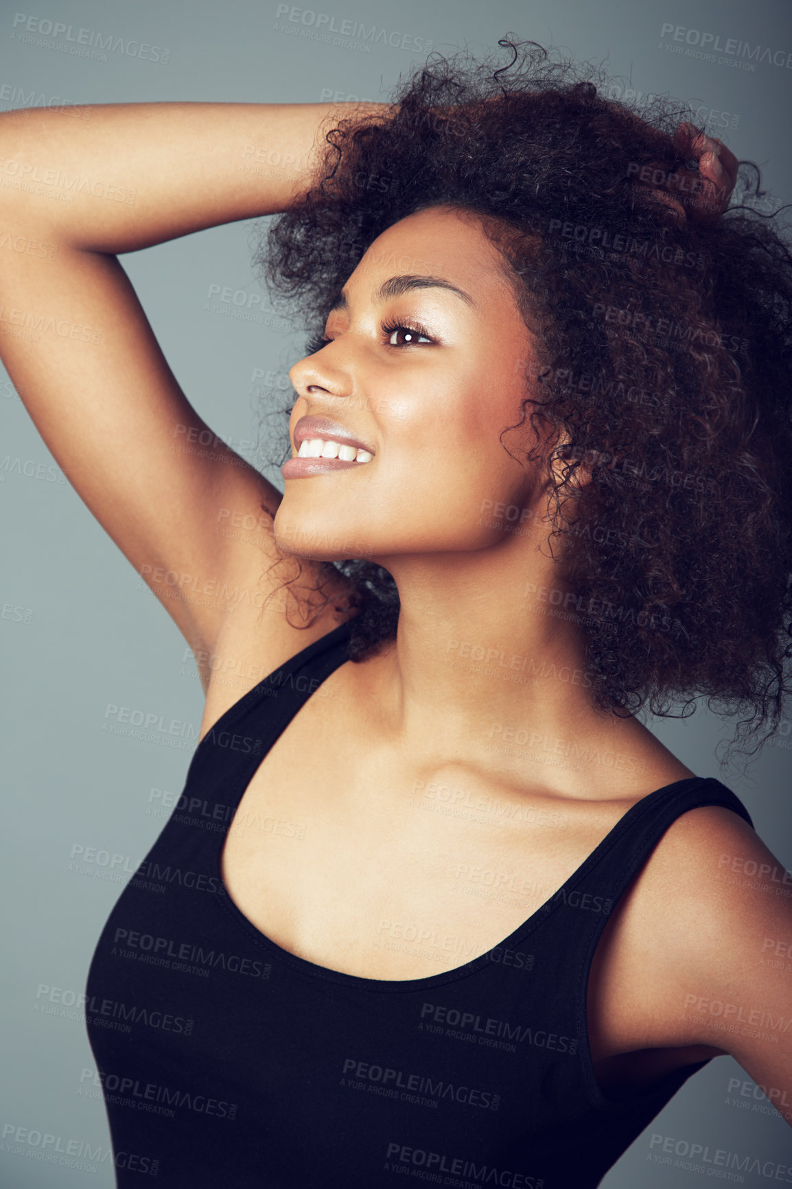 Buy stock photo Woman, afro and hair care for natural beauty in studio or curly treatment, grey background or mockup space. Female person, smile and grooming confidence or healthy wellness, texture pride or volume