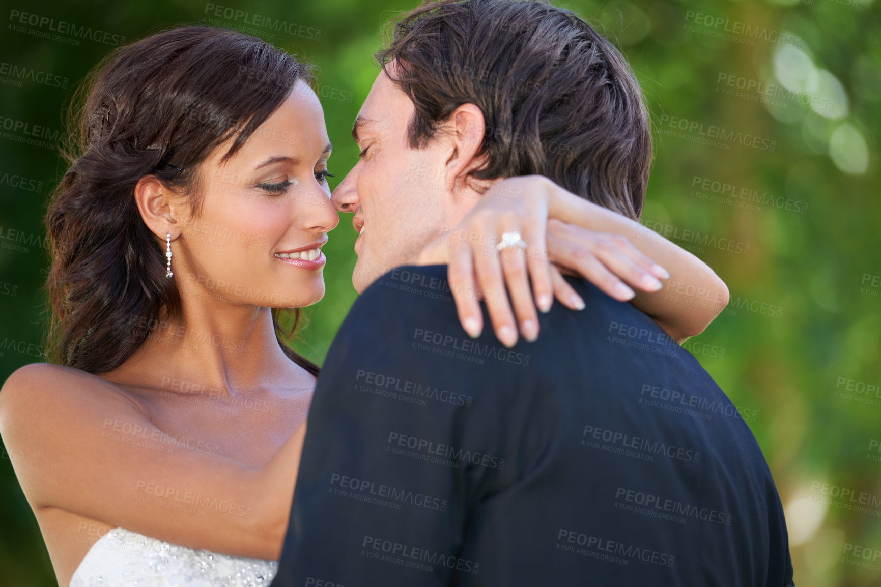 Buy stock photo Wedding day, kiss and bride and groom in garden for event, celebration or union outdoor. Love, hug and happy couple embrace at marriage, ceremony or event with support, trust and romance at a park