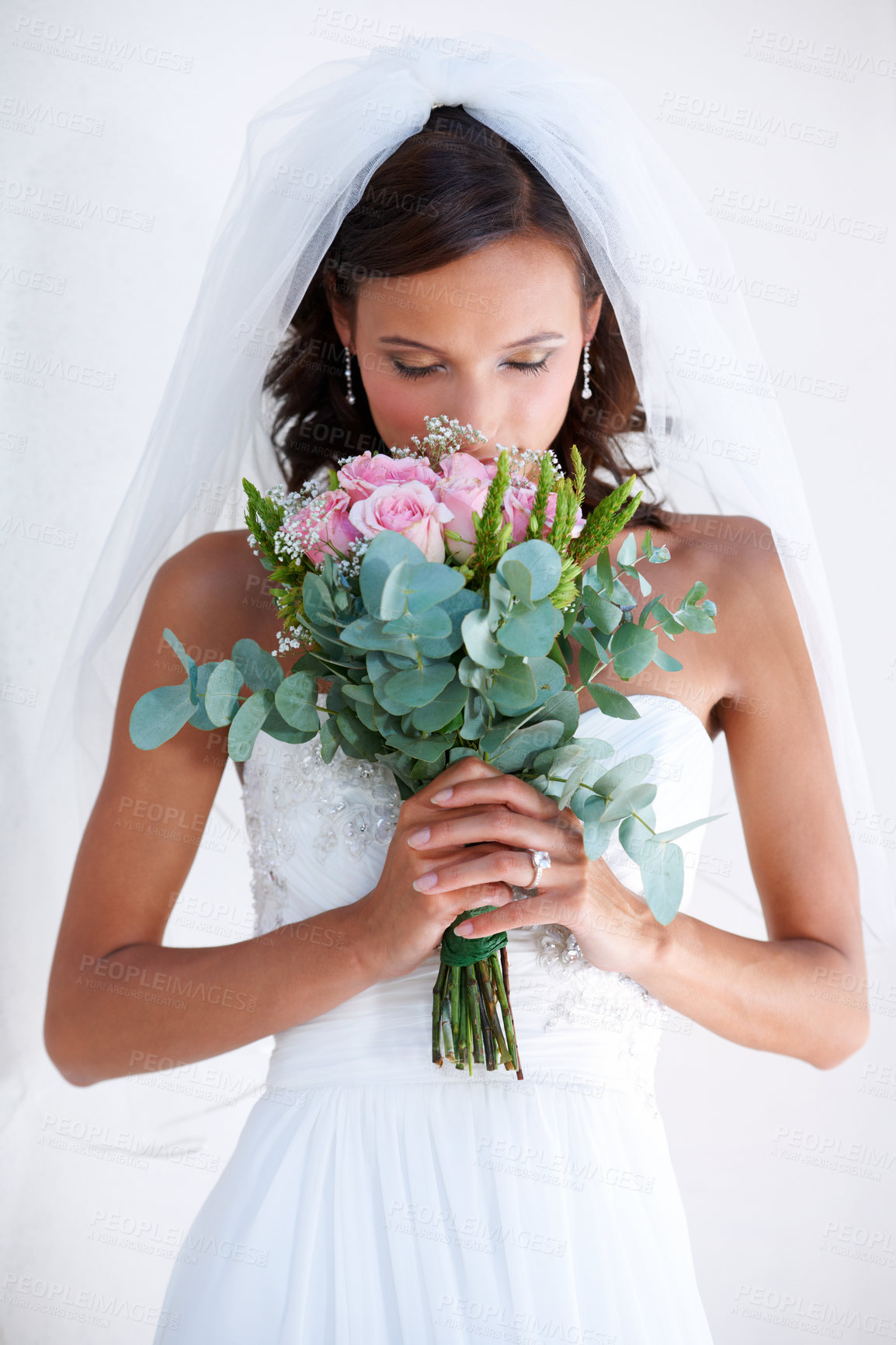 Buy stock photo A gorgeous young bride smelling her bouquet