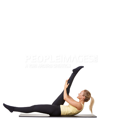 Buy stock photo A fit young woman stretching out her legs on an exercise mat - isolated